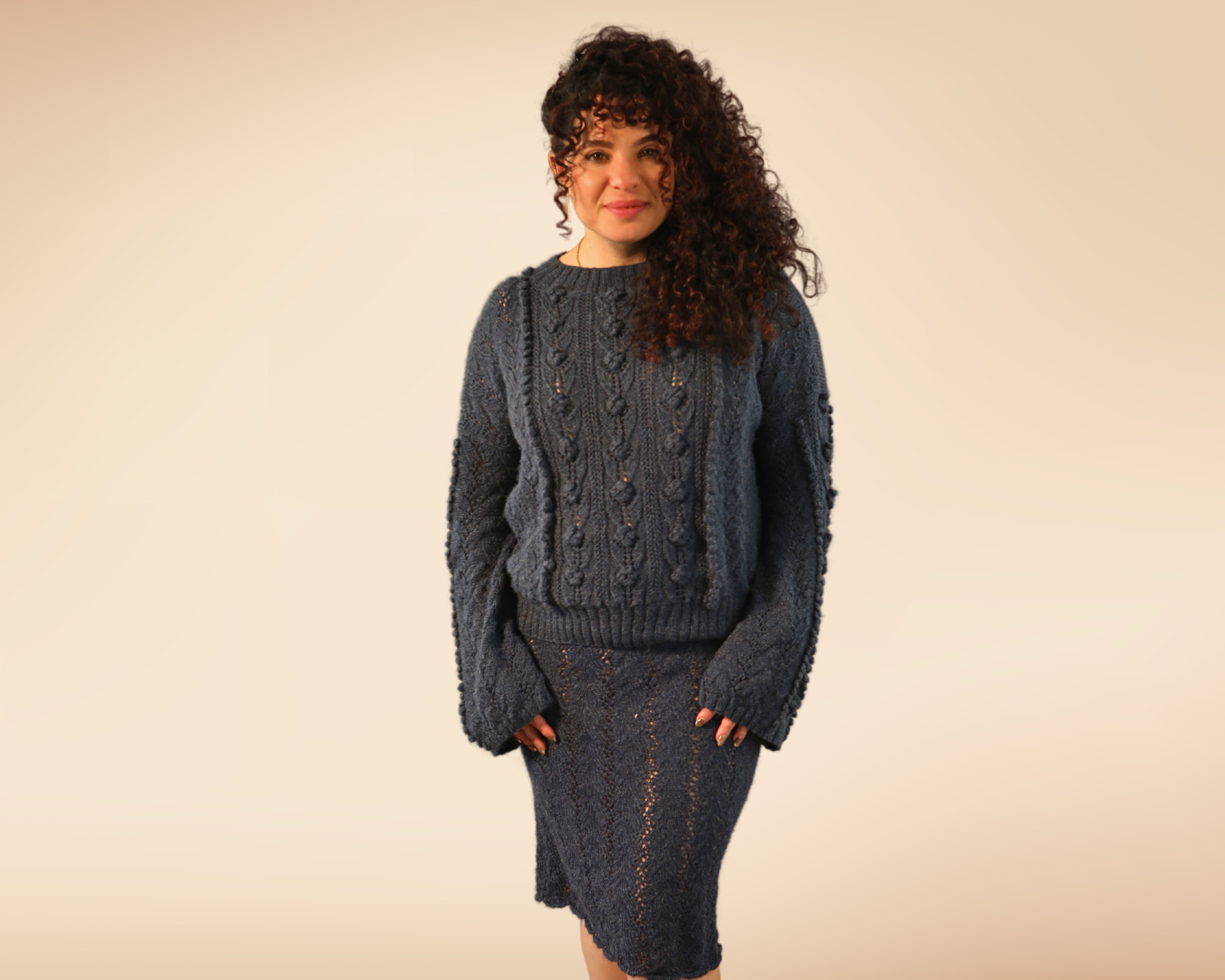 Nadine standing with the rose sweater and foliage skirt