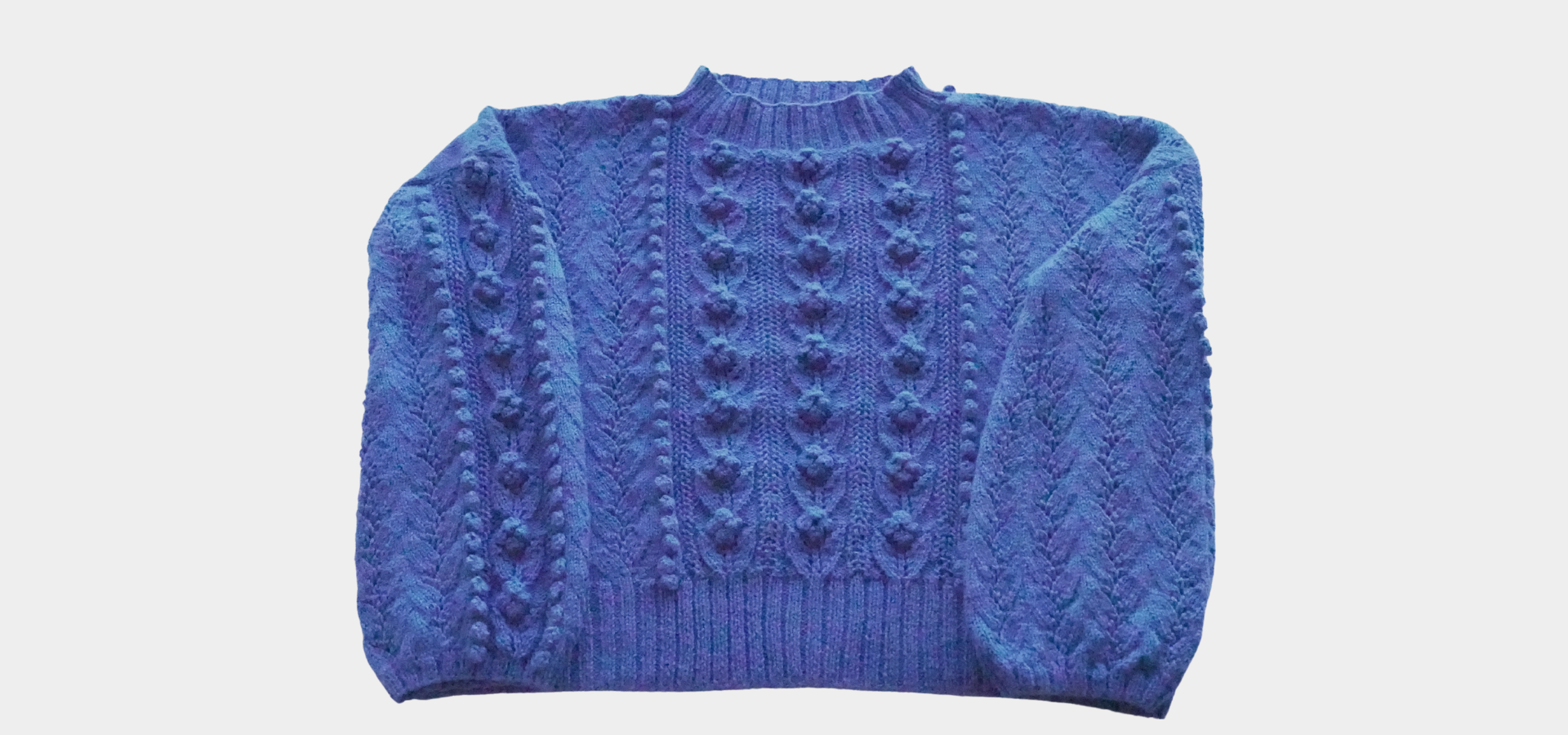 Front flat view of the Rose Sweater showcasing its detailed design.